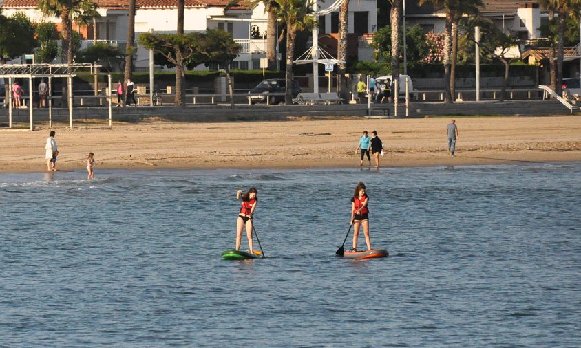 Dues persones fen pàdel surf a la platja del Regueral, aquesta setmana