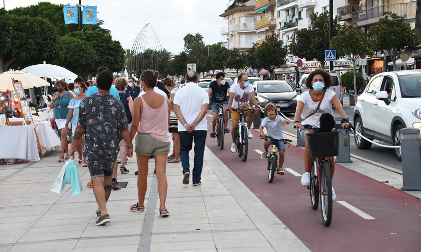 Vianants, ciclistes i vehicles a la façana del port de Cambrils, l'estiu passat